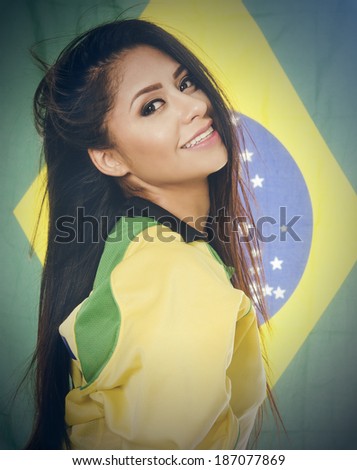 Happy smiling beautiful young woman in Brazil yellow and green colors