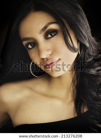 Beautiful exotic young woman\'s face dark sultry looks