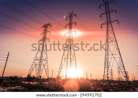 Electrical power lines as sun sets in background