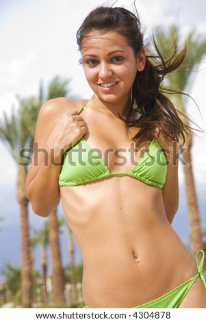 stock photo Beautiful young swimsuit model hair blowing in the tropical 