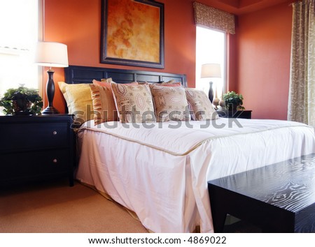Beautiful colorful vibrant bedroom with rich stylish decor.  The artwork has been modified to avoid copy right issues.