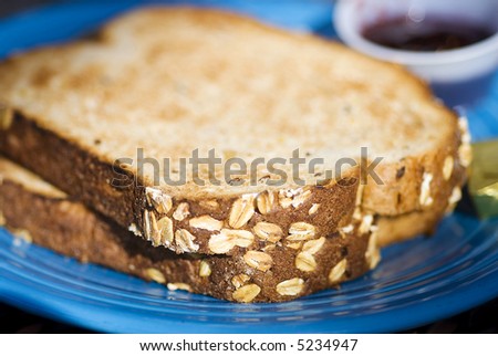 Macro shot of wheat grain bread. Focus is on the grains on the crust of the bread.