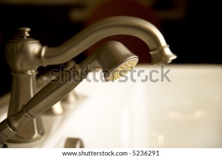 Elegant deluxe Bathtub faucets in soft dramy lighting.