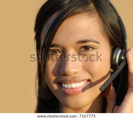 Young attractive bi-racial sales support woman on telephone