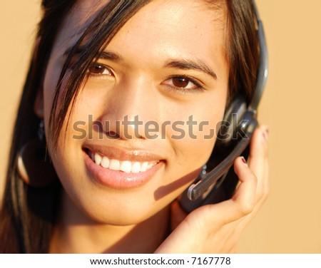 Young attractive friendly customer service answering customer questions on the telephone