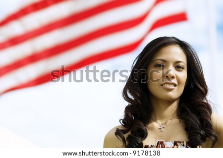 Beautiful Asian American Woman with the stripes of the American flag behind her.