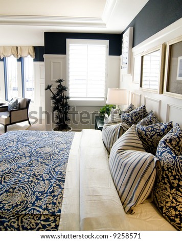 Beautifully designed bedroom interior with white and blue coloring and shutters