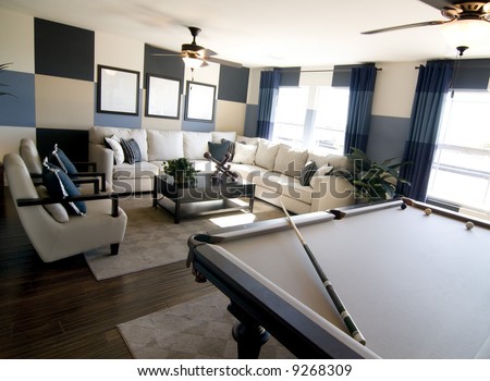 Stylish modern luxury game room interior design with pool table in foreground.