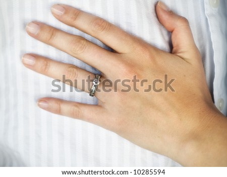 Engagement ring, hand on chest