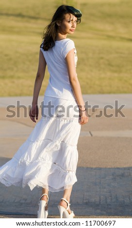 Beautiful young model walking and turning to look back