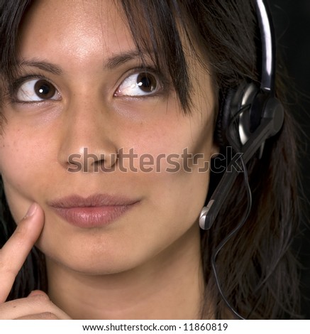 Young woman in customer service ponders a question or request from a customer before answering