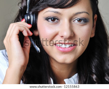 Young business woman is talking by headl phone
