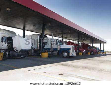Trucks at gas pump station off highway