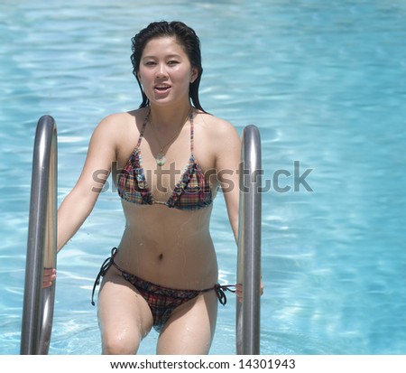 Woman stepping out of swimming pool