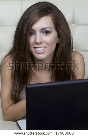 Young woman at home relaxing and having fun on her laptop computer