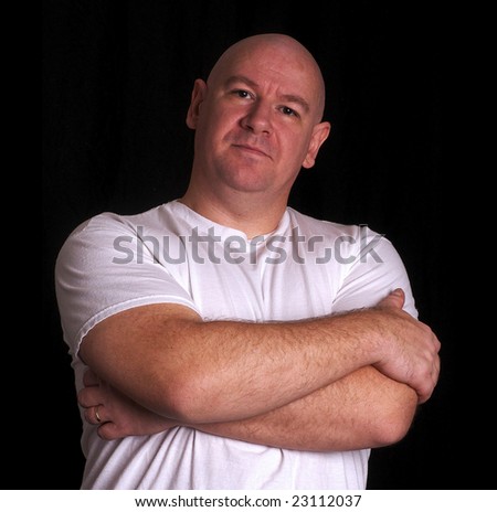 Serious looking man with shaved head