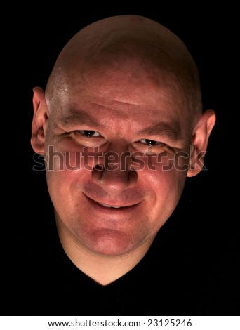 Character shot of shaved head man with sinister smile