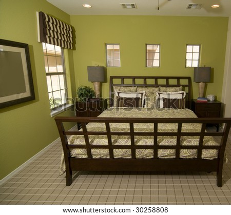 Beautiful wooden bed frame in bright green colored room