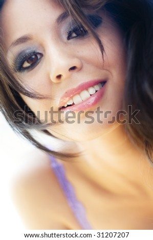 Candid sweet moment of beautiful young woman caught in playful happy mood.