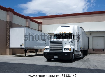 Large truck unloading at warehouse bay