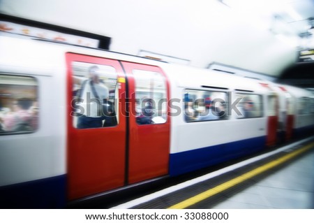 London tube train speeding through station, images cross processed.