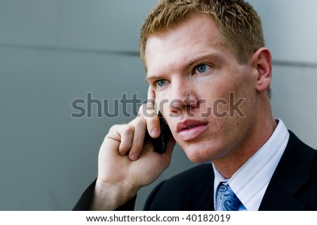 Business man taking a phone call on mobile phone outside