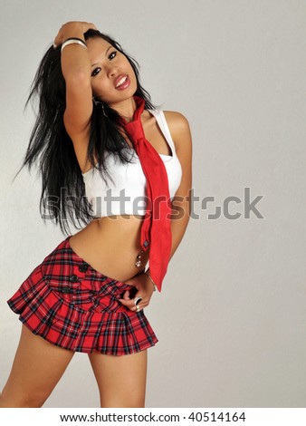 Cute attractive Asian woman wearing mini plaid skirt