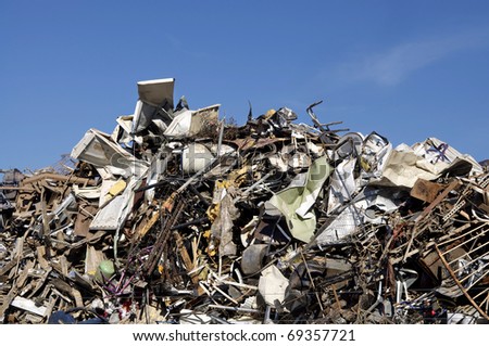 Huge pile of scrap metal junk garbage with blue sky background
