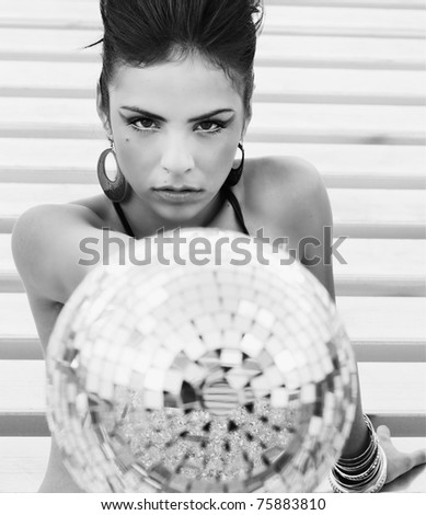 Beautiful model holding silver disco ball