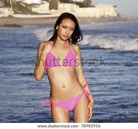 Pretty young woman in ocean wearing bikini