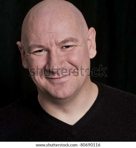 Portrait of a wise charming smiling shaved headed man