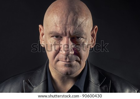 Actor portraying menacing man with  shaved head.