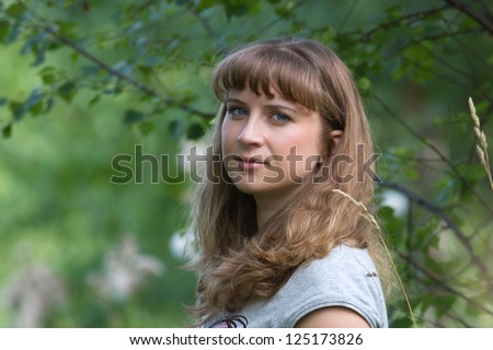 Portrait of a young girl in a summer forest