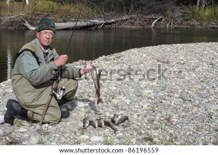 Fisherman after a successful fishing on the river