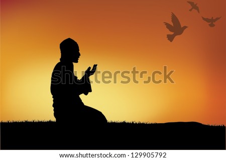 Silhouette of a Muslim praying during sunset.