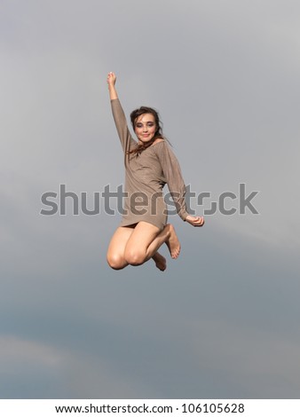 happy young woman jumping for joy, smiling