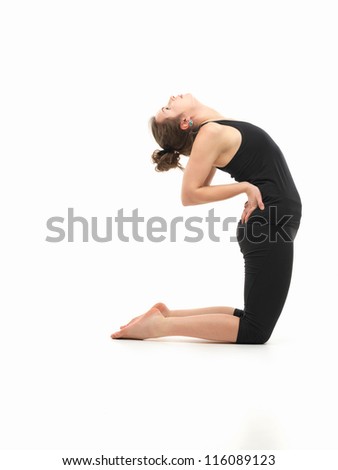 young attractive woman in balancing yoga pose, side view, dressed in black on white background