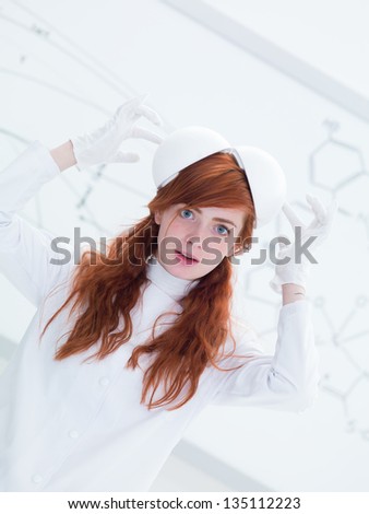 general-view of a pretty face girl student in a chemistry lab playing with lab tools and a  white-board on the background