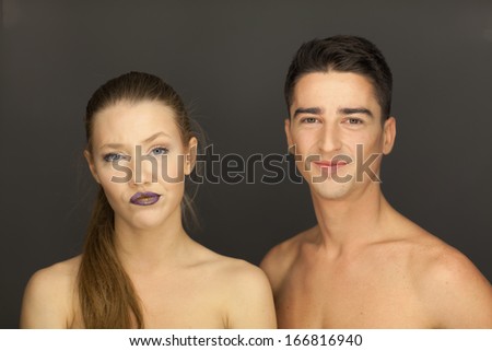 beautiful couple in studio portrait front view pose for the camera, the man behind
