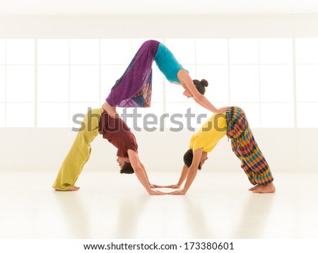 people dressed in vibrant colors perform yoga moves
