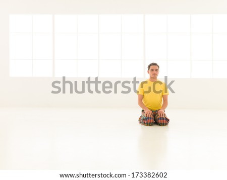 young man preparing for yoga lessons in gym vibrant color
