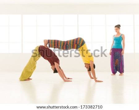people dressed in vibrant colors perform yoga moves