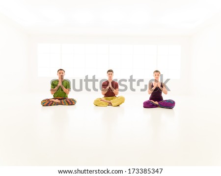 Three young people practice, yoga class