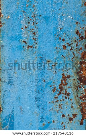 Old metal plate painted blue with rust