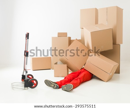 delivery man laying on floor covered in cardboard boxes