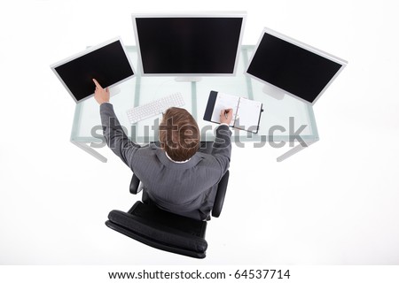 Businessman in his clean high tech office looking on the monitors upper view