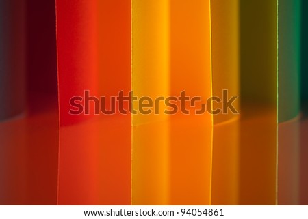 background image of colorful origami vertical pattern made of curved sheets of paper, with mirror reflexion