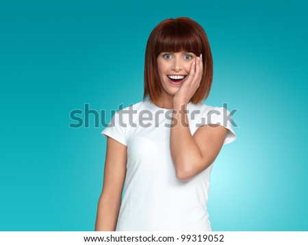 beautiful, young woman, with a surprised face expression, on blue background