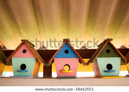 Colorful bird houses under the roof with nice lighting and leading lines