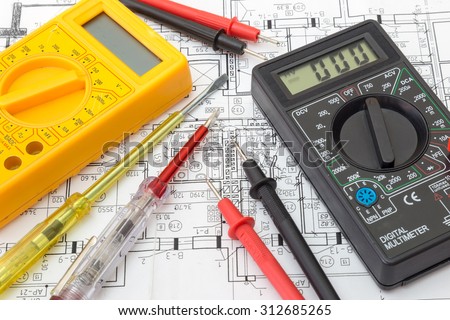 Still Life Of Electrical Components Arranged On Plans. Centered on testers (digital multimeters)